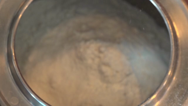 White powder being poured into a kettle