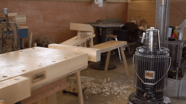 Woodworking tools and stove in a cozy carpentry workshop
