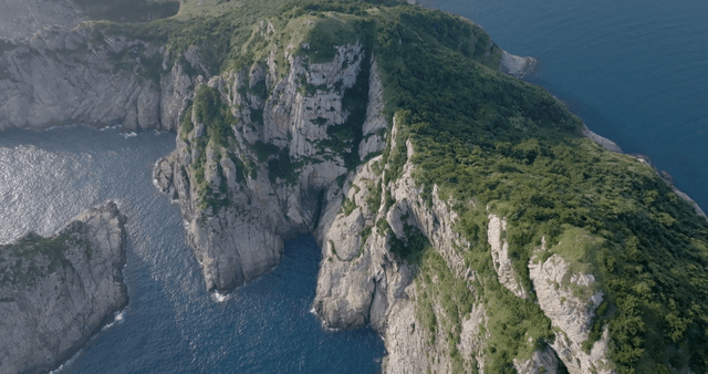 Aerial view of a rocky cliff by the sea