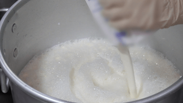 Milk being poured into a pot