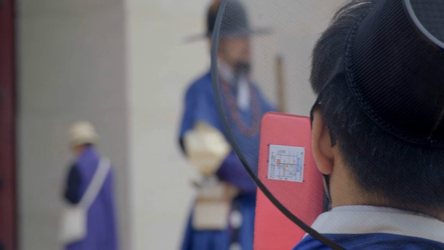 Person taking pictures of a traditional chief gatekeeper ceremony