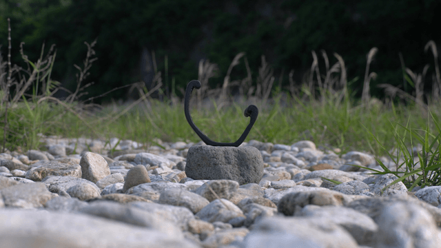Wooden sculpture placed in a gravel field