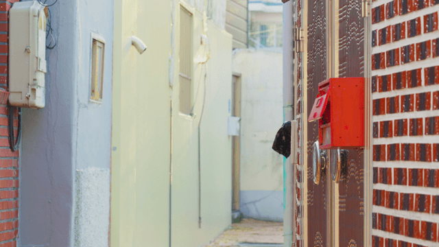 Narrow alley with red mailbox