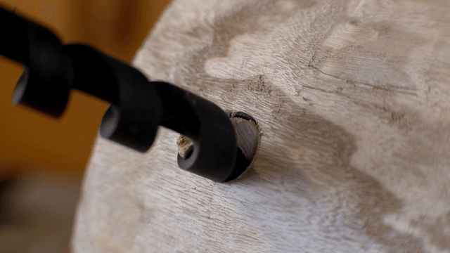 Spiral drill making precise holes in wooden barrel