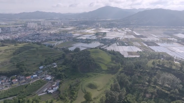 Aerial view of rural farmland and cityscape