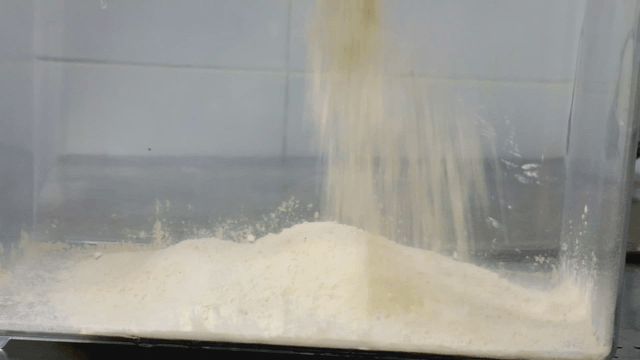 Flour being poured into a container