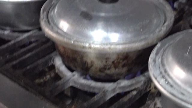 Rice cooking in a pot on a stove