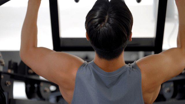 Man exercising on a pull-up machine