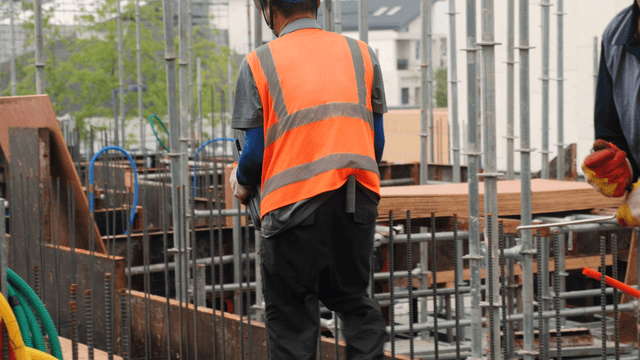 Construction workers carrying materials