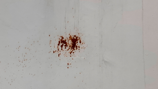 Red stains on a white wall