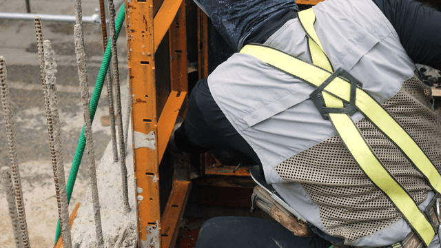 Worker adjusting construction framework