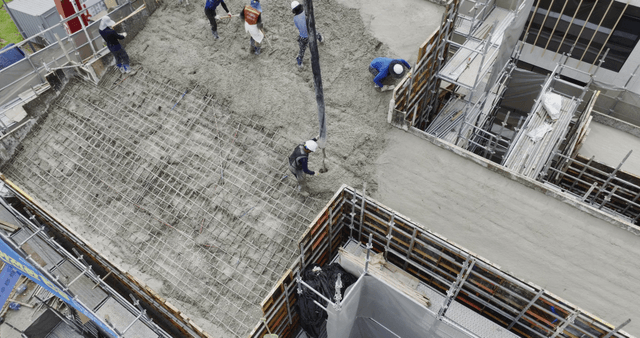 Workers pouring concrete on a building site