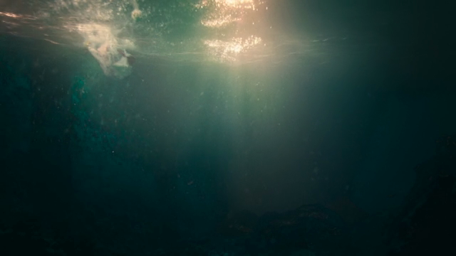 A person in water with sunlight shining on him