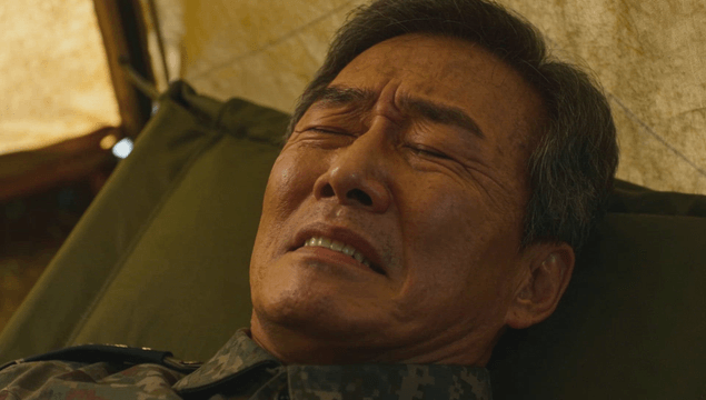 Suffering officer lying on a field bed