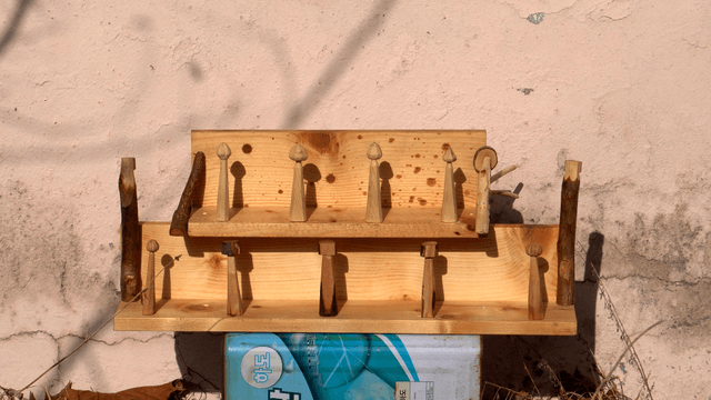 Handcrafted wooden shelves stacked on an iron container