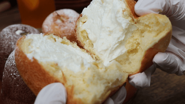 Cream-filled bread being torn open
