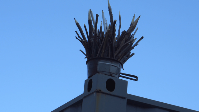 Wooden pencil sculpture under the clear sky