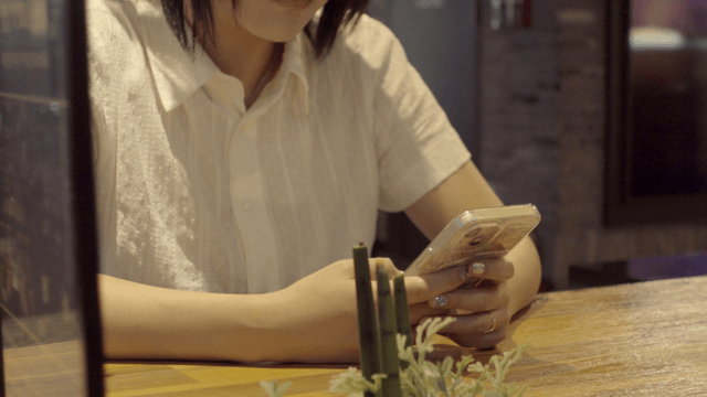 Woman using a smartphone at a cafe