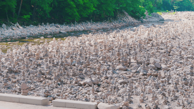 Numerous stone towers stacked along riverside