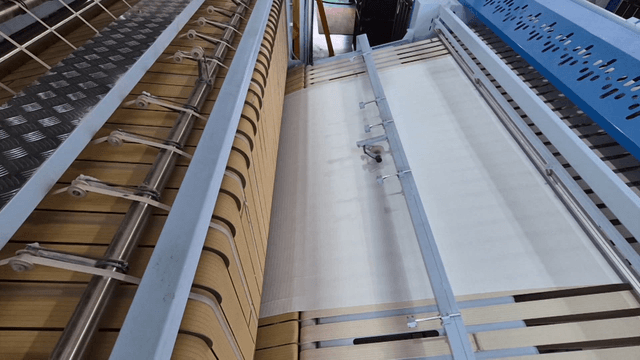 Large fabric ironing machine in laundry factory