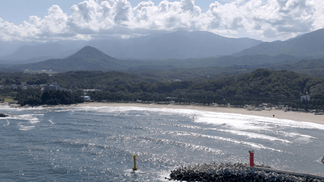 Coastal view with mountains and lighthouse