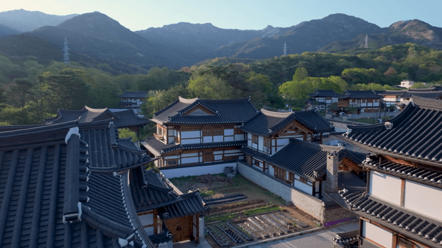 Traditional hanok village with mountain backdrop
