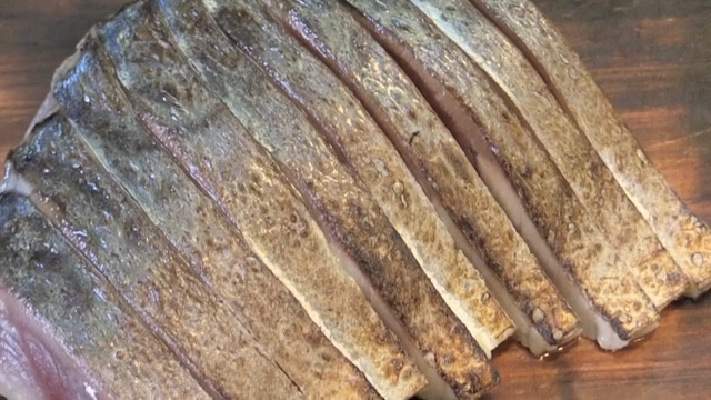 Sliced raw mackerel on a cutting board
