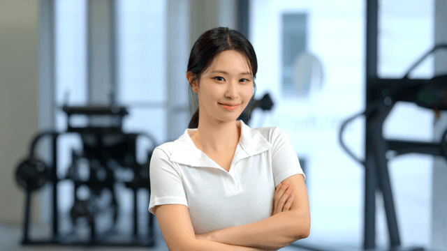 Confident woman smiling forward in gym
