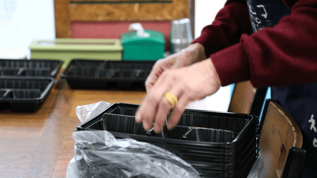 Preparing food containers on a table