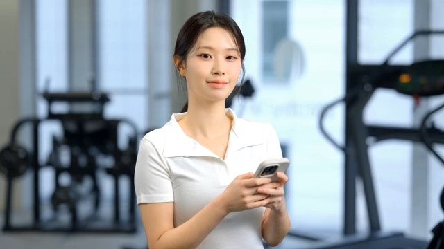 Woman using a smartphone in a gym