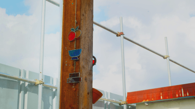 Stained glass on a wooden pillar under clear sky