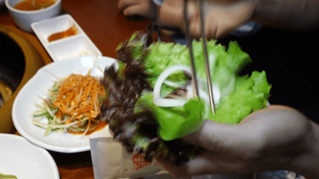 Seasoned grilled ribs with onion and ssamjang lettuce wrap