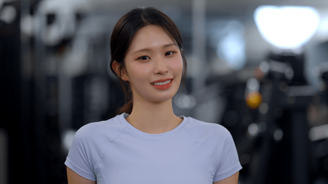 Young woman smiling forward in gym