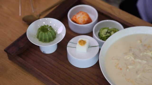 A tray with Korean dishes on a table
