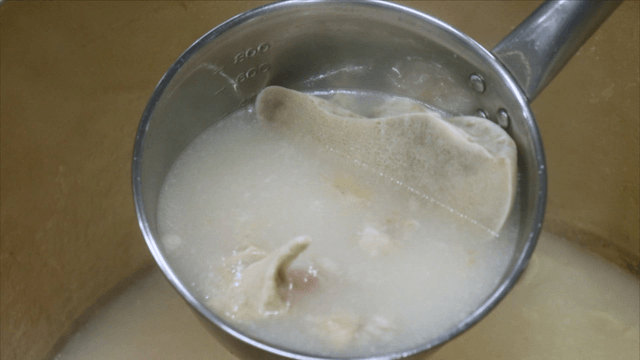 Korean beef bone broth in a ladle