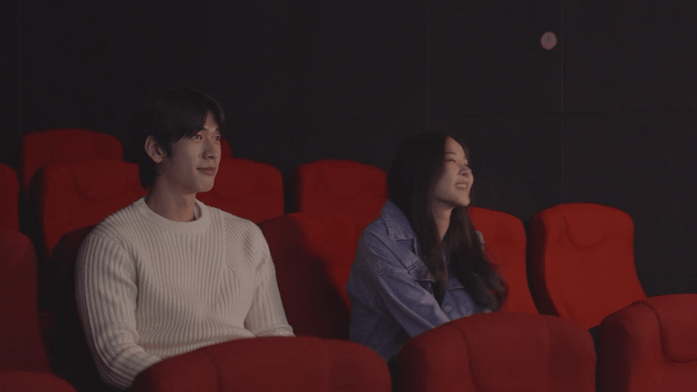 Couple enjoying a movie in a theater