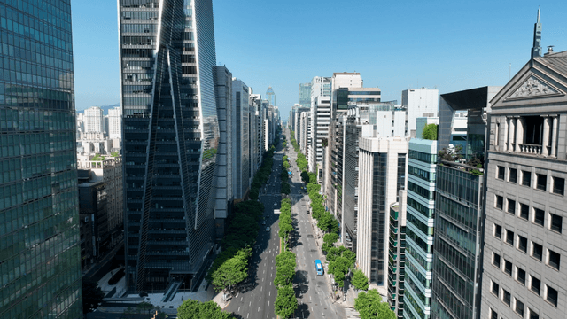 A bustling city street lined with skyscrapers