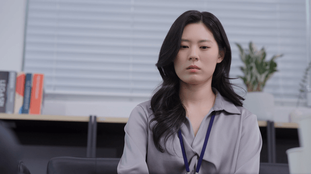 A woman with a nervous expression in the office