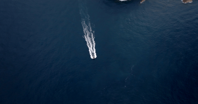 A boat cruising near rocky islands