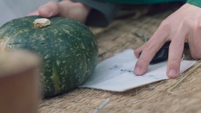 Hands holding letters in pumpkin