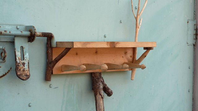 Wooden shelf with a rustic design attached to a metal door