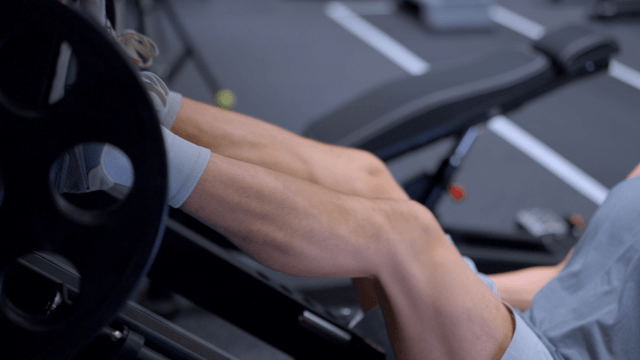 Man exercising on a leg press machine