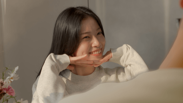 Couple smiling while taking photo in cozy home