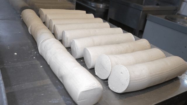 Cylindrical buckwheat dough neatly arranged for resting