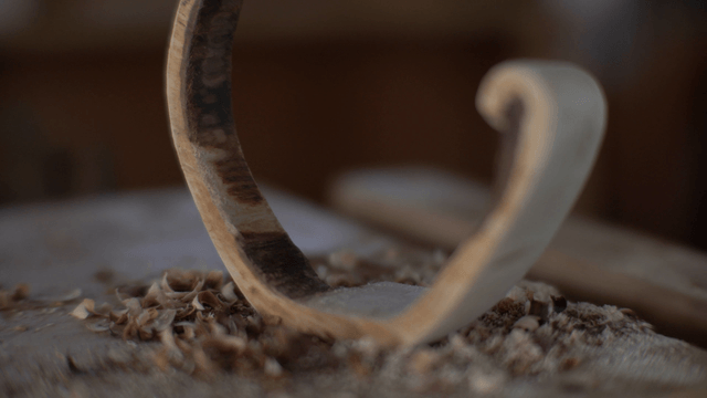 Semi-circular wooden piece on workbench