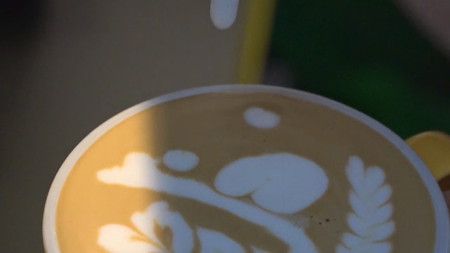 Latte art being created in a coffee cup