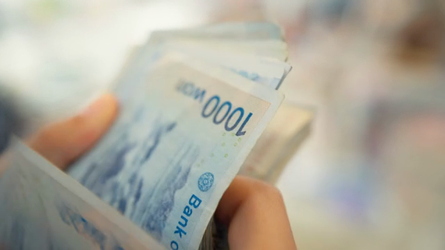 Counting Korean banknotes in hand