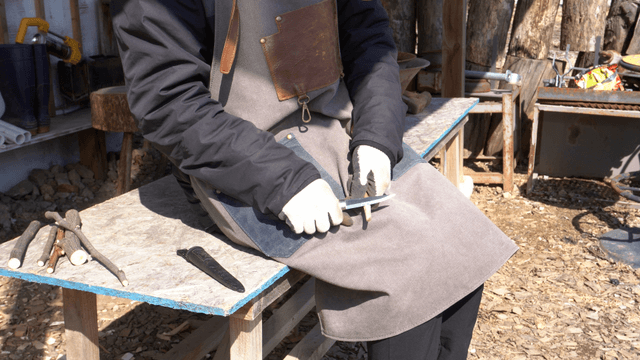 Woodcraft artisan carving wood on outdoor workbench