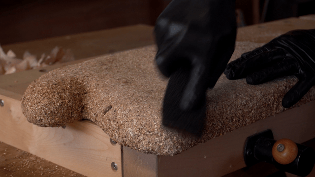 Artisan delicately sanding a cork sculpture