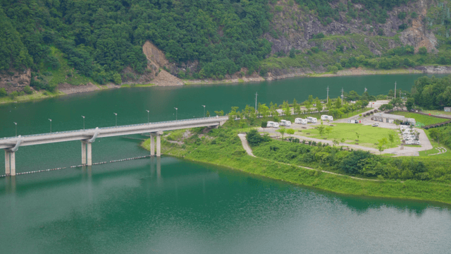 Lake landscape with bridge and campsite